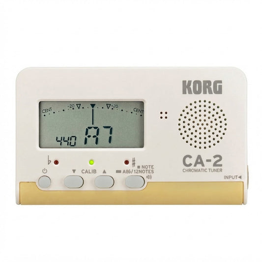 Korg CA-2 Chromatic Tuner electronic device in off-white and gold, featuring a digital display screen, four control buttons, and a circular speaker grille on a white background.